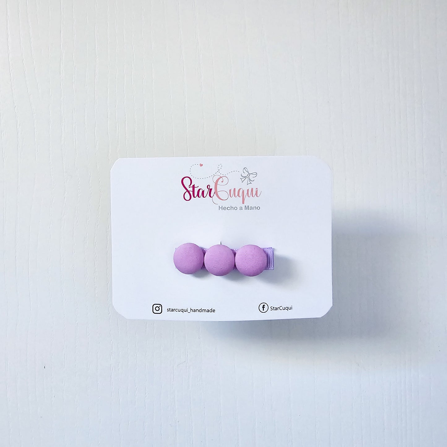 Pinza botón violeta