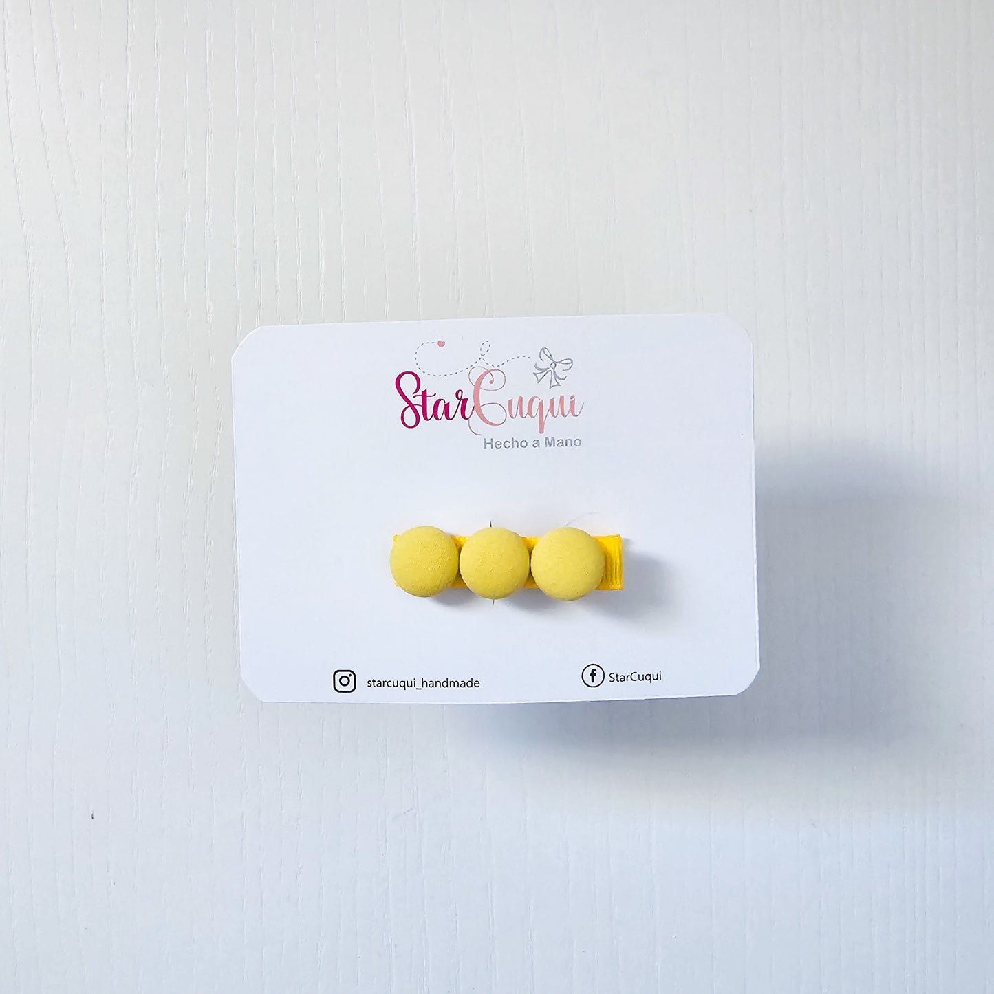 Pinza botón amarillo