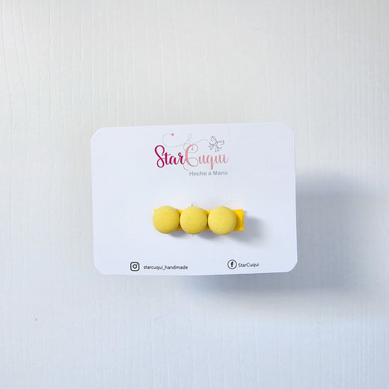 Pinza botón amarillo
