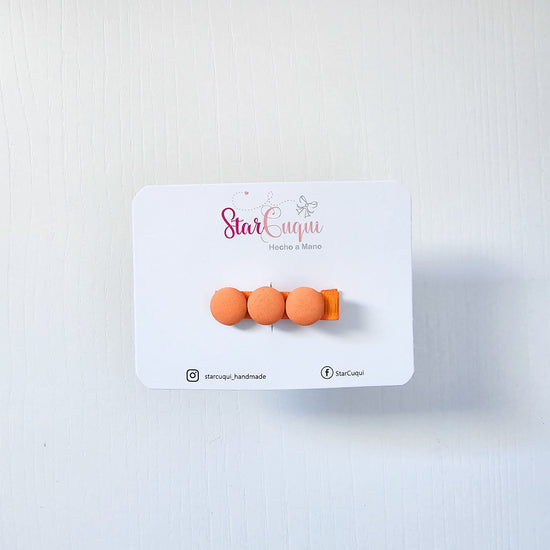 Pinza botón naranja